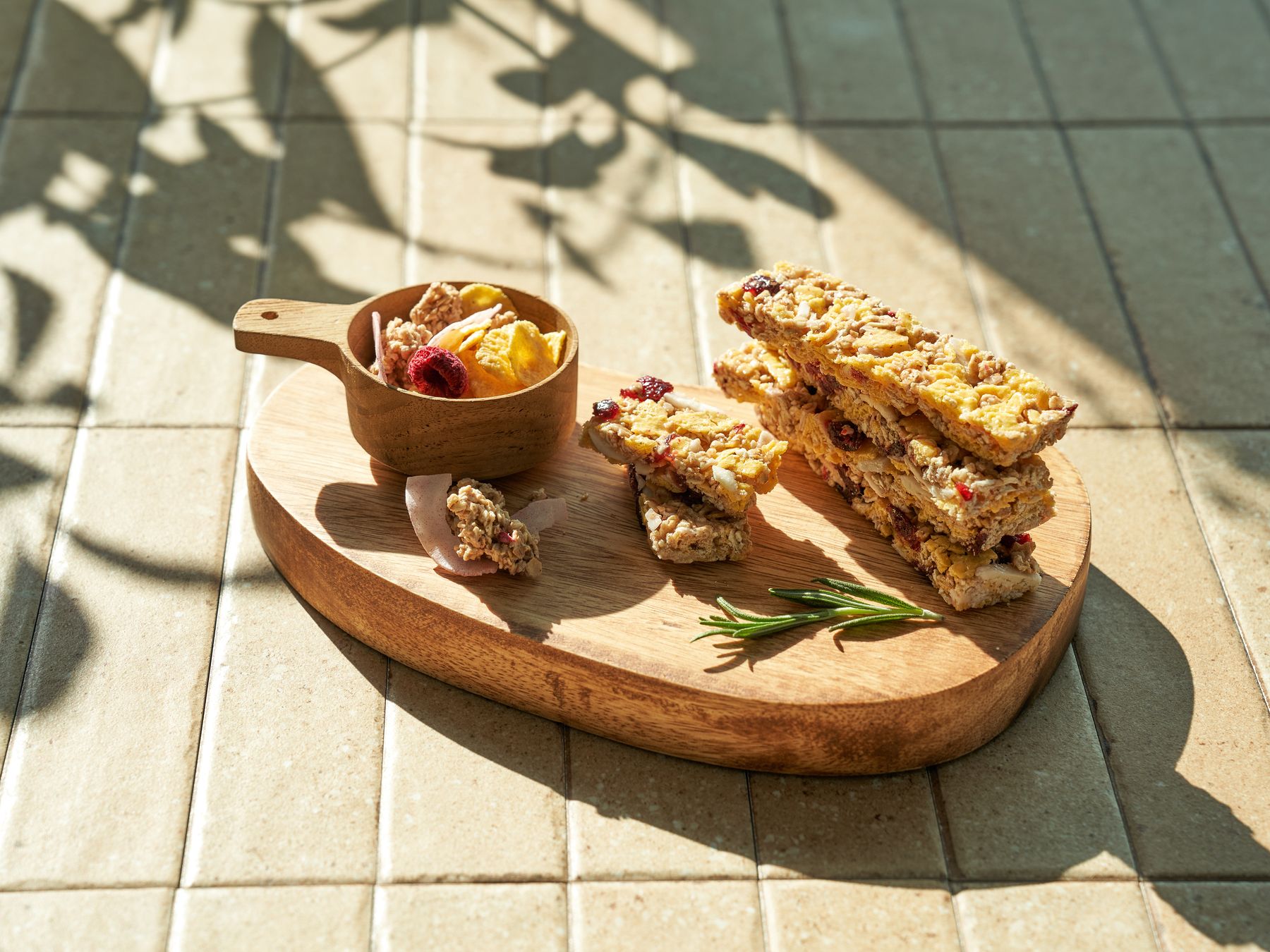 YOUGAONE organic snack bars styled on a wooden board in warm light