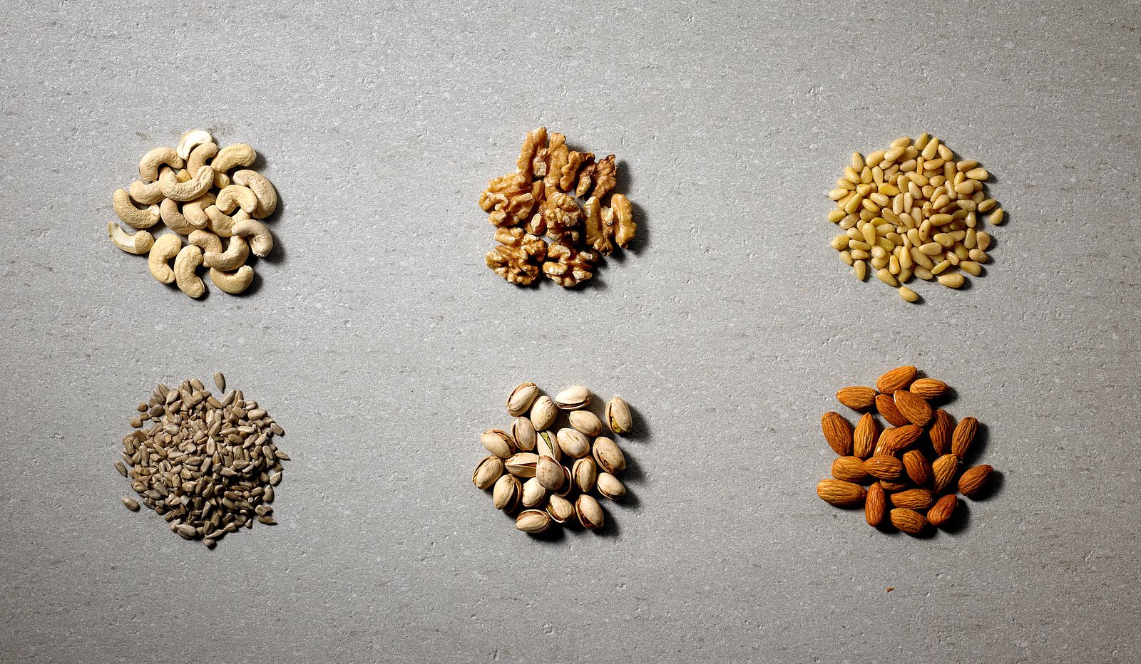 Raw organic nuts and seeds in neat piles